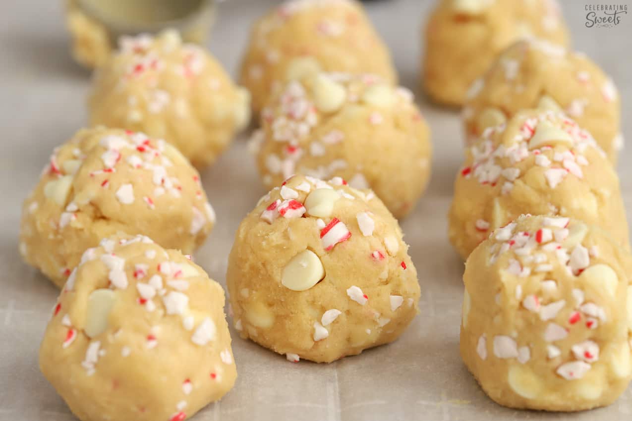 Cookie dough balls topped with crushed peppermint candies and white chocolate chips.