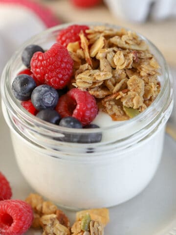 Yogurt, granola, and berries in a jar.