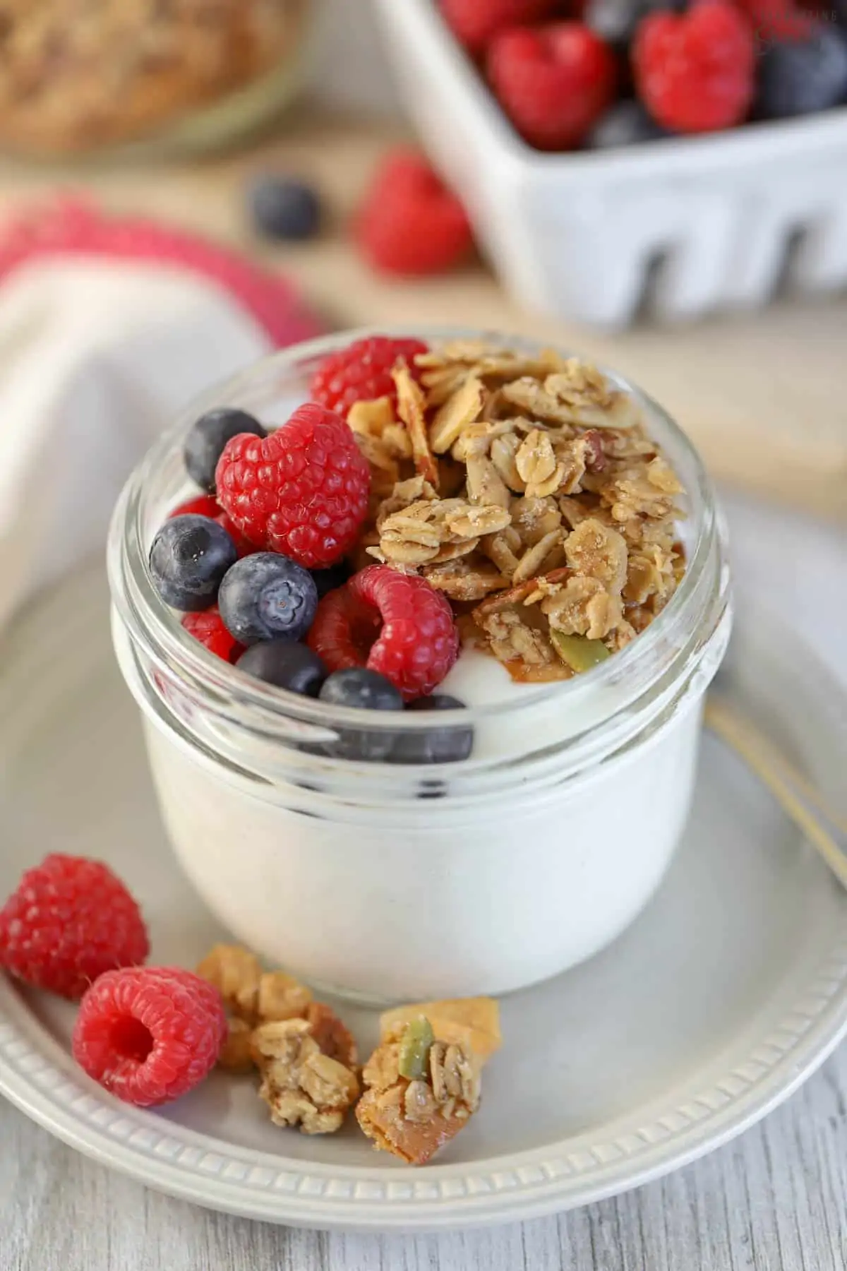 Yogurt, granola, and berries in a jar.