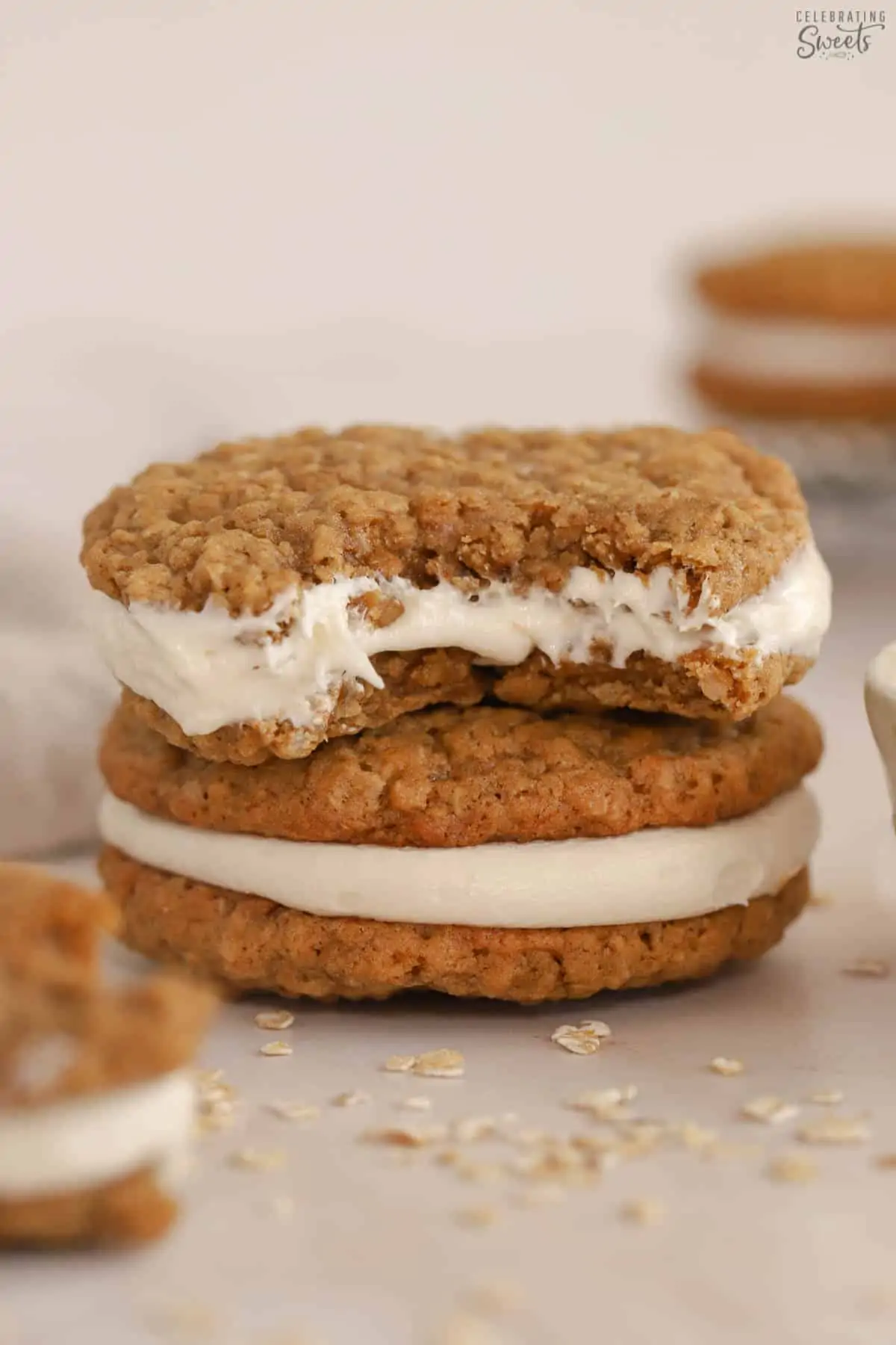 Stack of two oatmeal cream pies with a bite taken out of the top one.