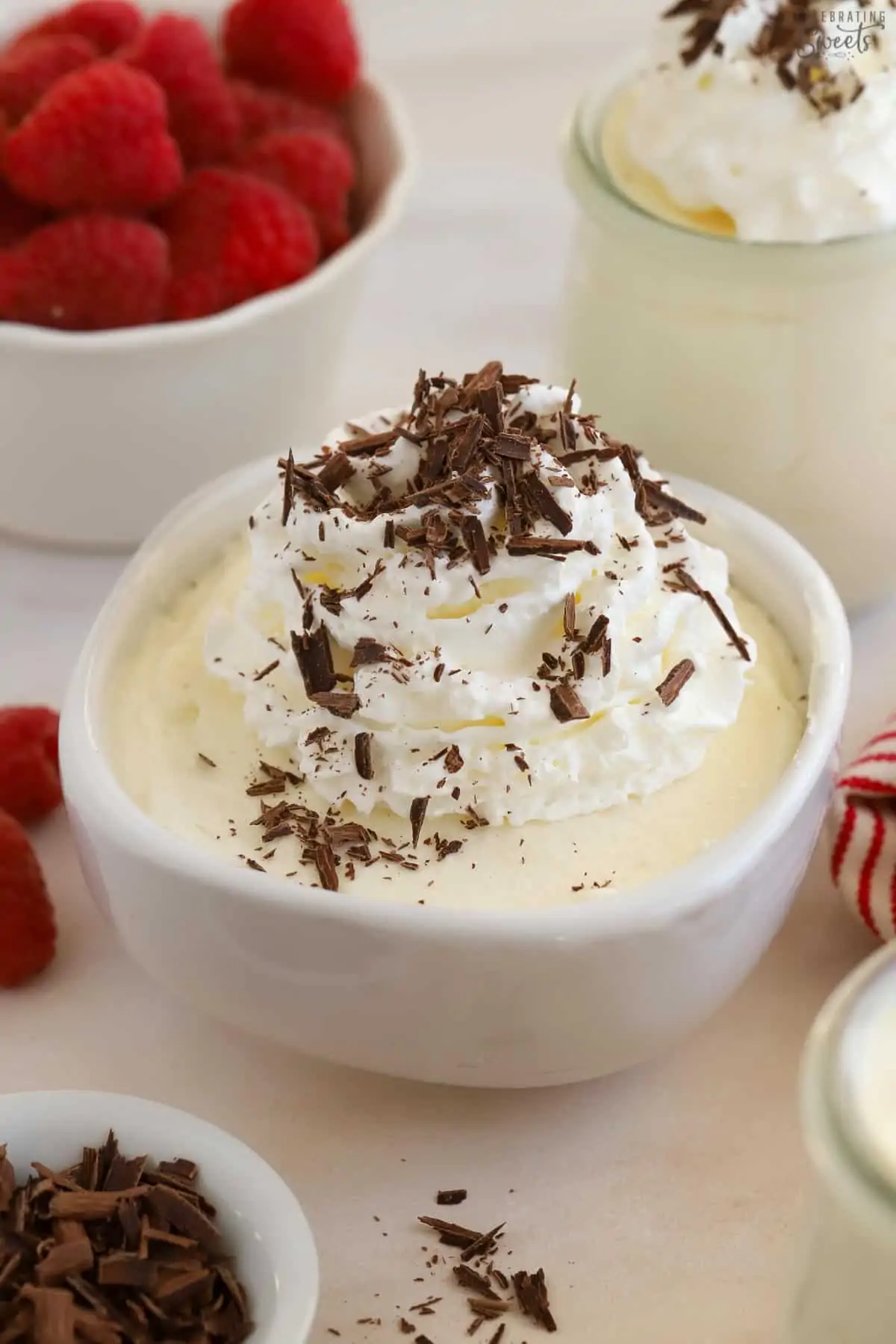 White chocolate mousse topped with whipped cream and chocolate shavings.