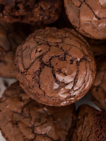 A stack of brownie bites on a white plate.