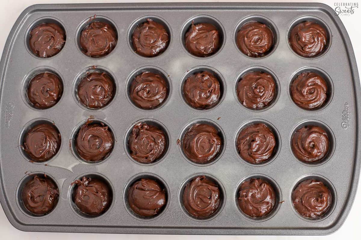 Brownie batter in a mini muffin pan.