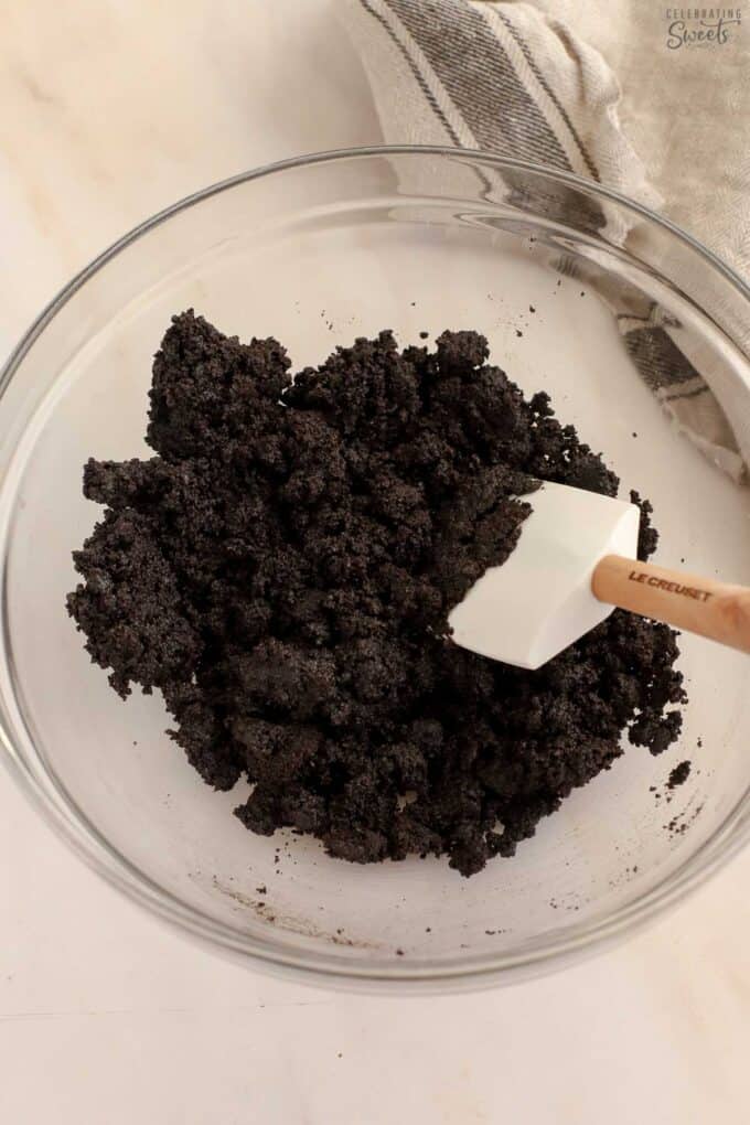 Oreo crumbs in a glass bowl.