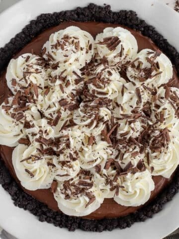 Chocolate pie topped with whipped cream and chocolate shavings.