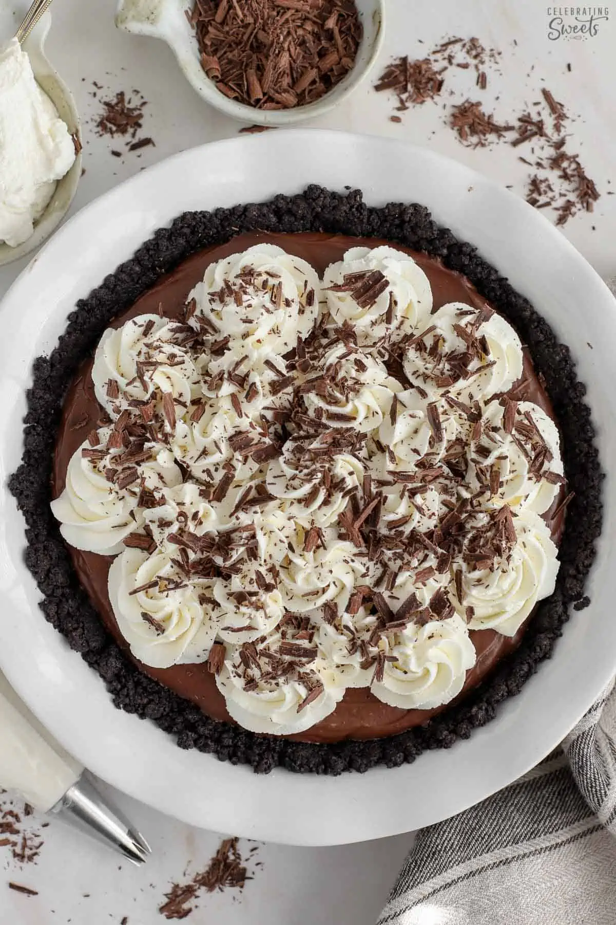 Chocolate pie topped with whipped cream and chocolate shavings.