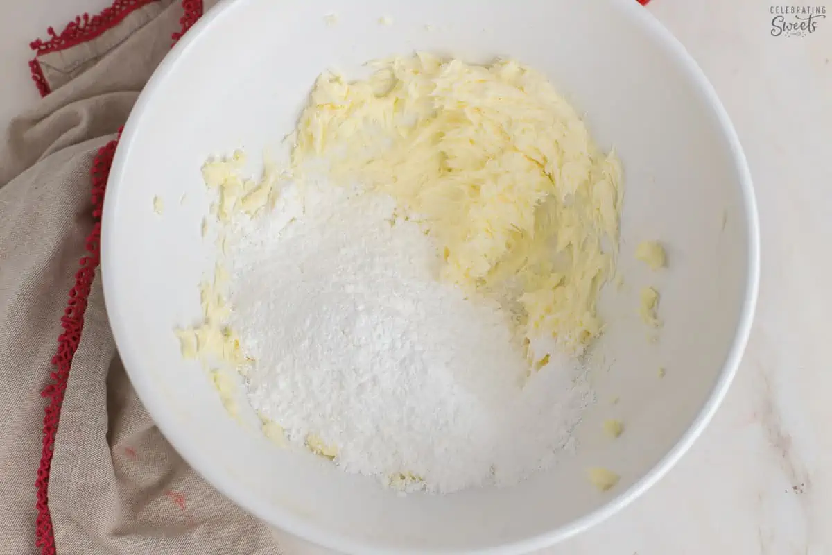 Butter and powdered sugar in a white bowl.