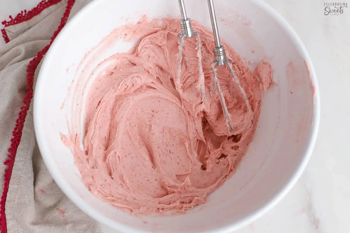 Strawberry frosting in a white bowl