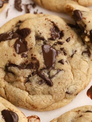 Chocolate chip cookies on parchment paper.