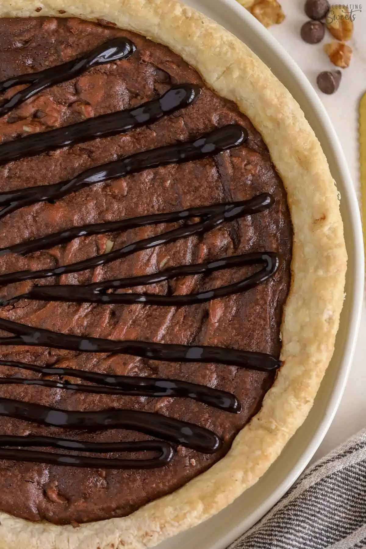 Brownie pie drizzled with chocolate sauce.