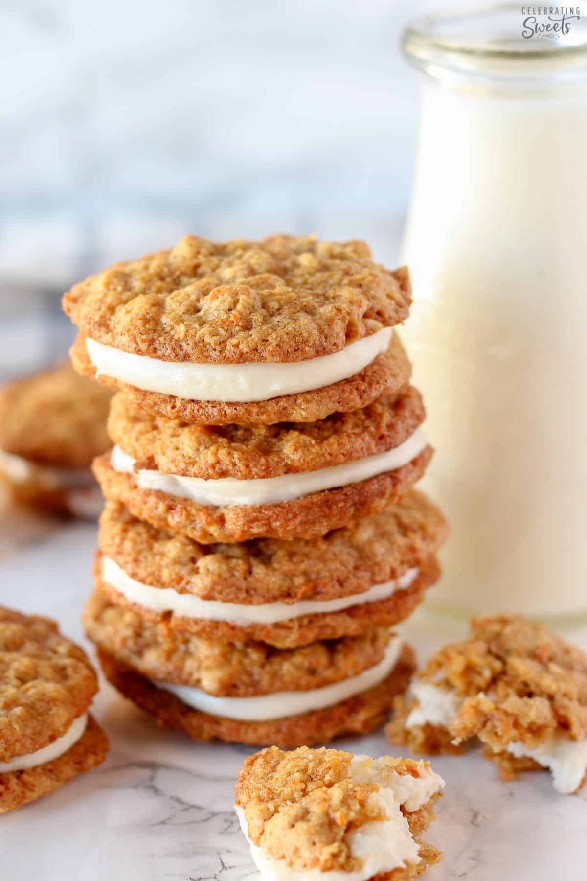 Stack of carrot cake cookies next to a glass of milk.
