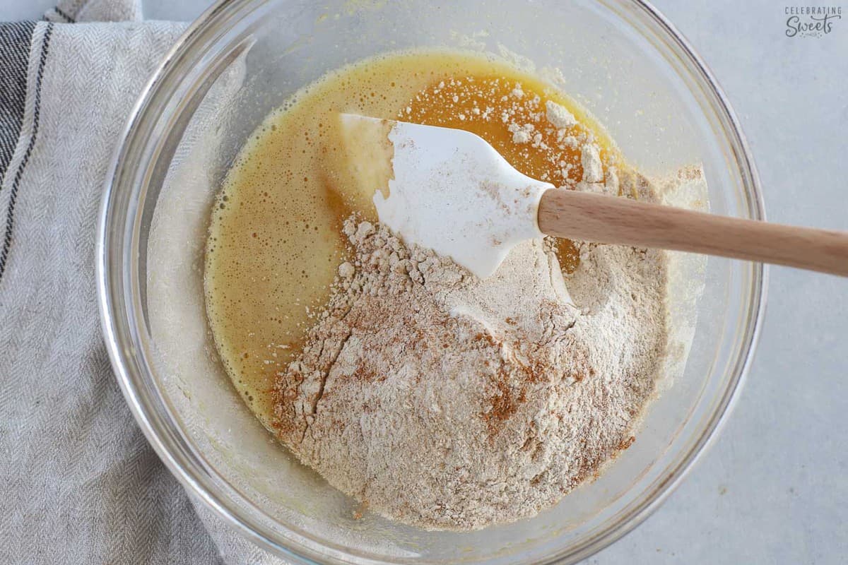Flour, cinnamon, eggs, sugar, in a glass bowl.