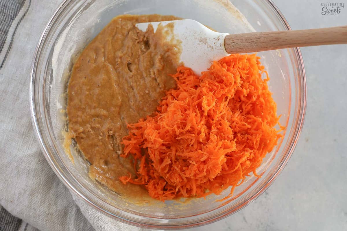 Carrot muffin batter in a glass bowl.
