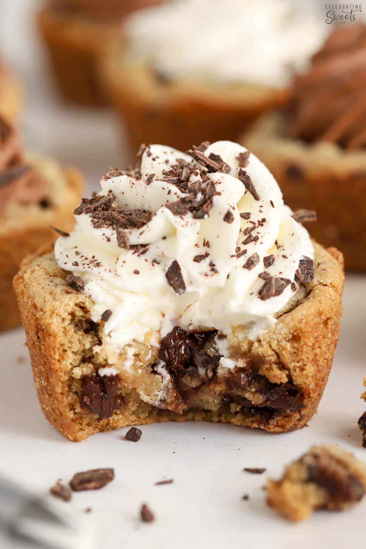 Chocolate chip cookie cup with a bite taken out of it.