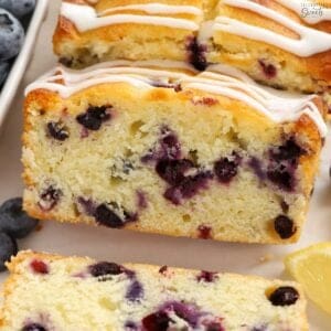 Slices of lemon blueberry bread with white icing drizzled over the top.