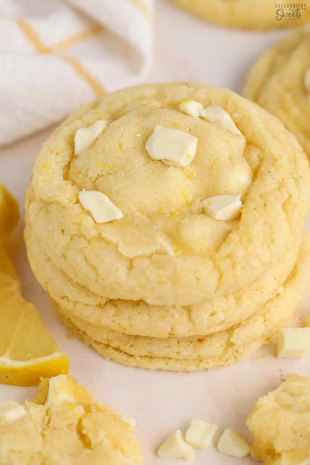 Stack of lemon cookies topped with white chocolate chunks.
