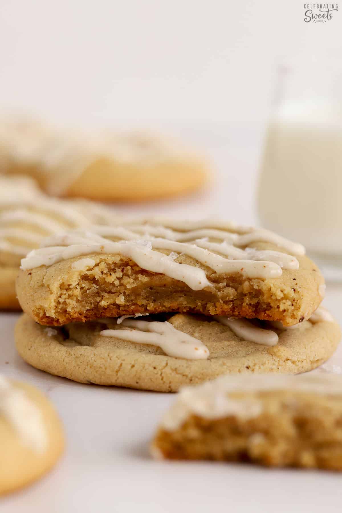 Closeup of a brown butter cookie with a bite take out of it.