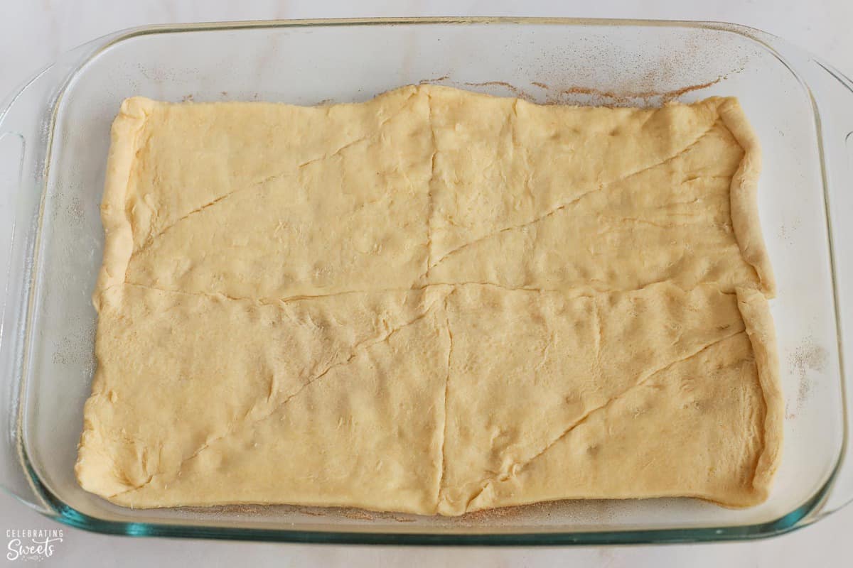 Crescent roll dough in a 9x13 glass pan.
