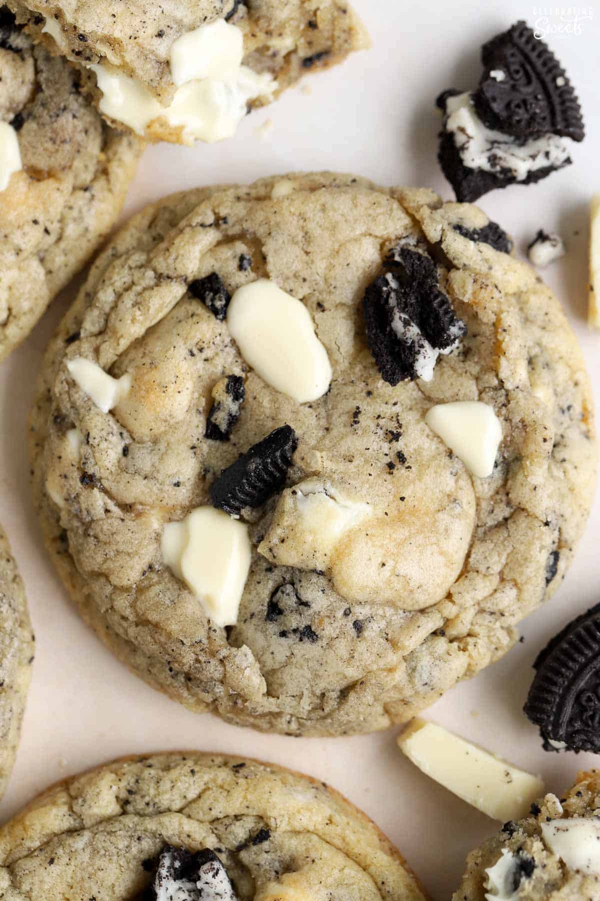 Closeup of a cookie filled with white chocolate and crushed oreos.