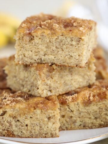 Stack of banana bread slices on a white plate.