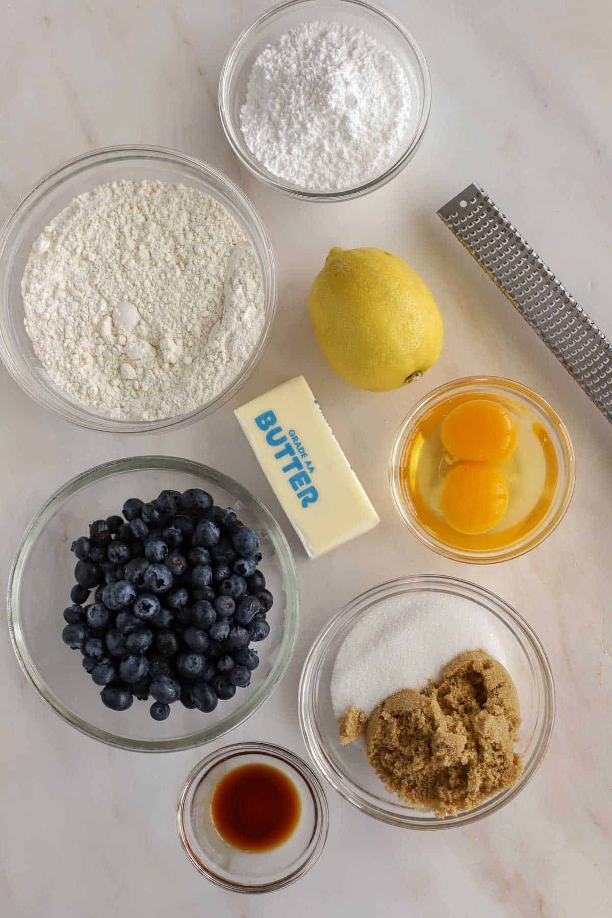 Ingredients for lemon blueberry bars: flour, blueberries, lemon, sugar, butter, eggs. vanilla.