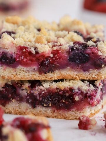 Stack of two berry crumble bars.