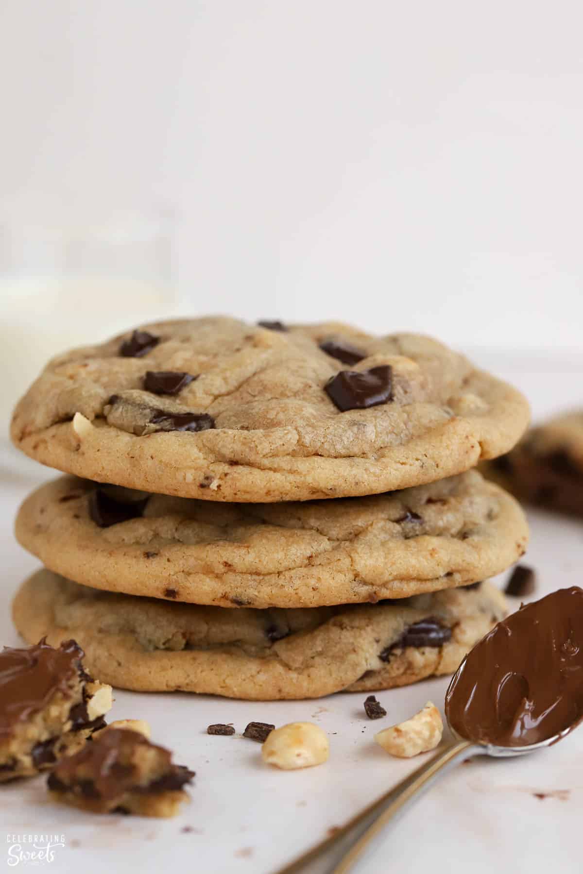 Stack of three Nutella chocolate chip cookies next to a spoonful of Nutella