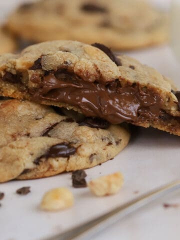 Cookie split open with Nutella filling inside.