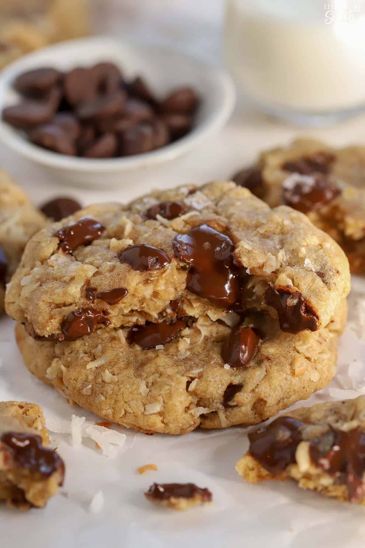 Oatmeal cookie broken in half filled with chocolate chips.