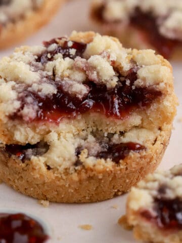 Stack of two raspberry crumble cookies.