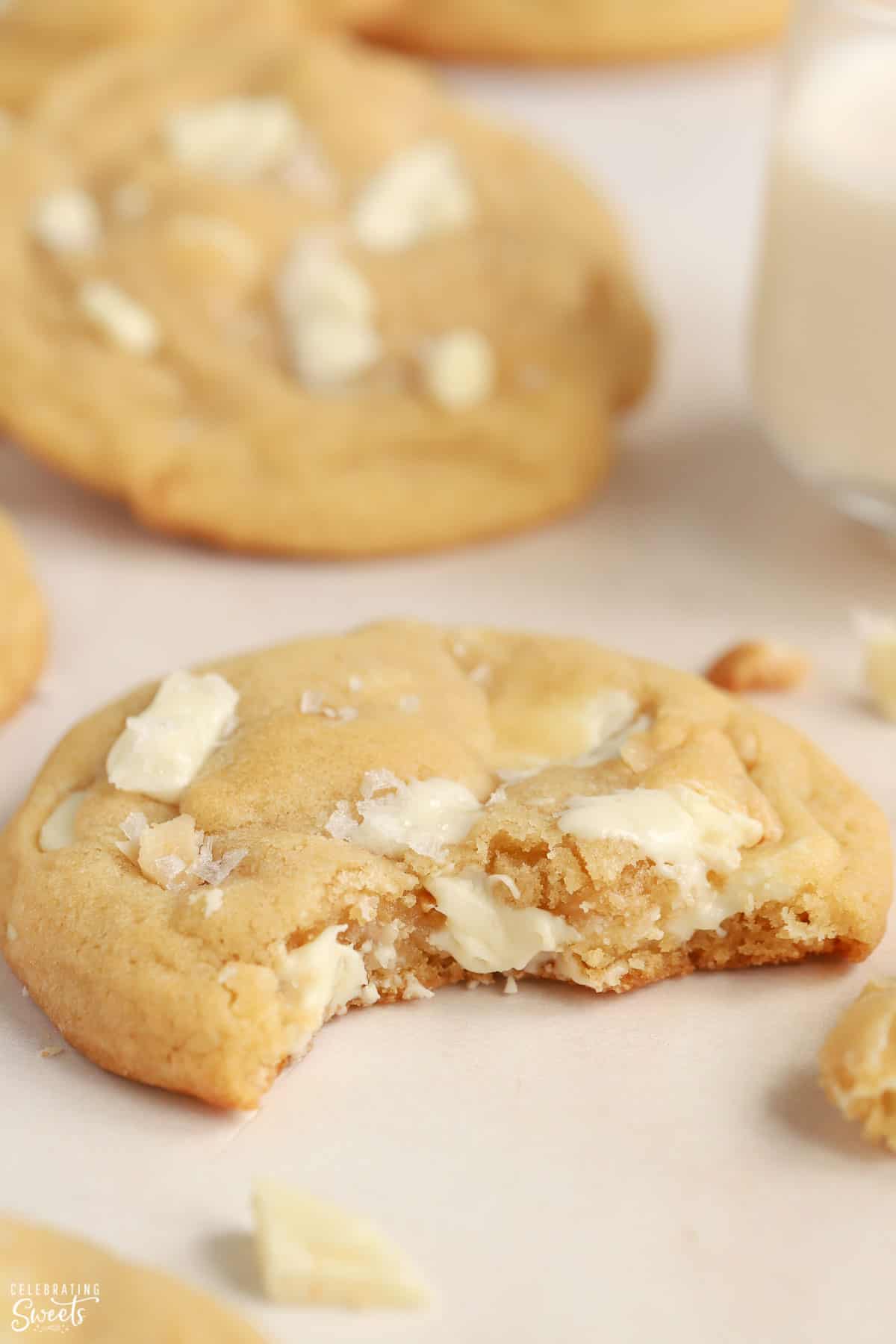 White chocolate macadamia nut cookie with a bite taken out of it.