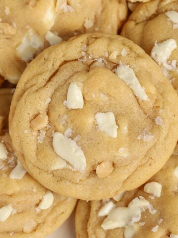 White chocolate macadamia nut cookies on a plate.