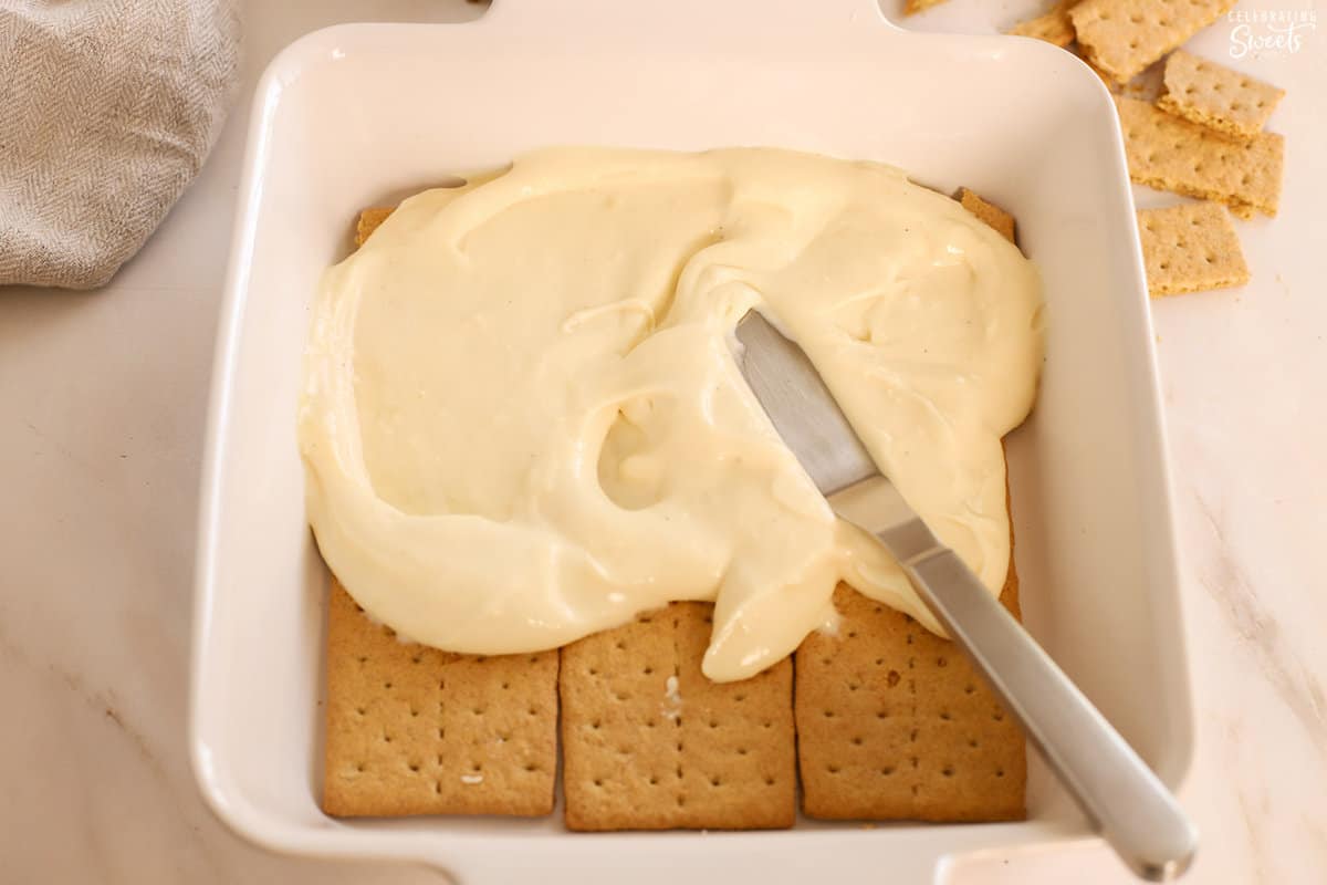 Pudding and graham crackers in a white baking dish.