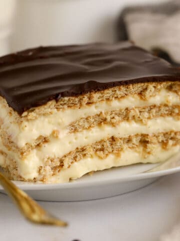 Slice of eclair cake on a white plate.