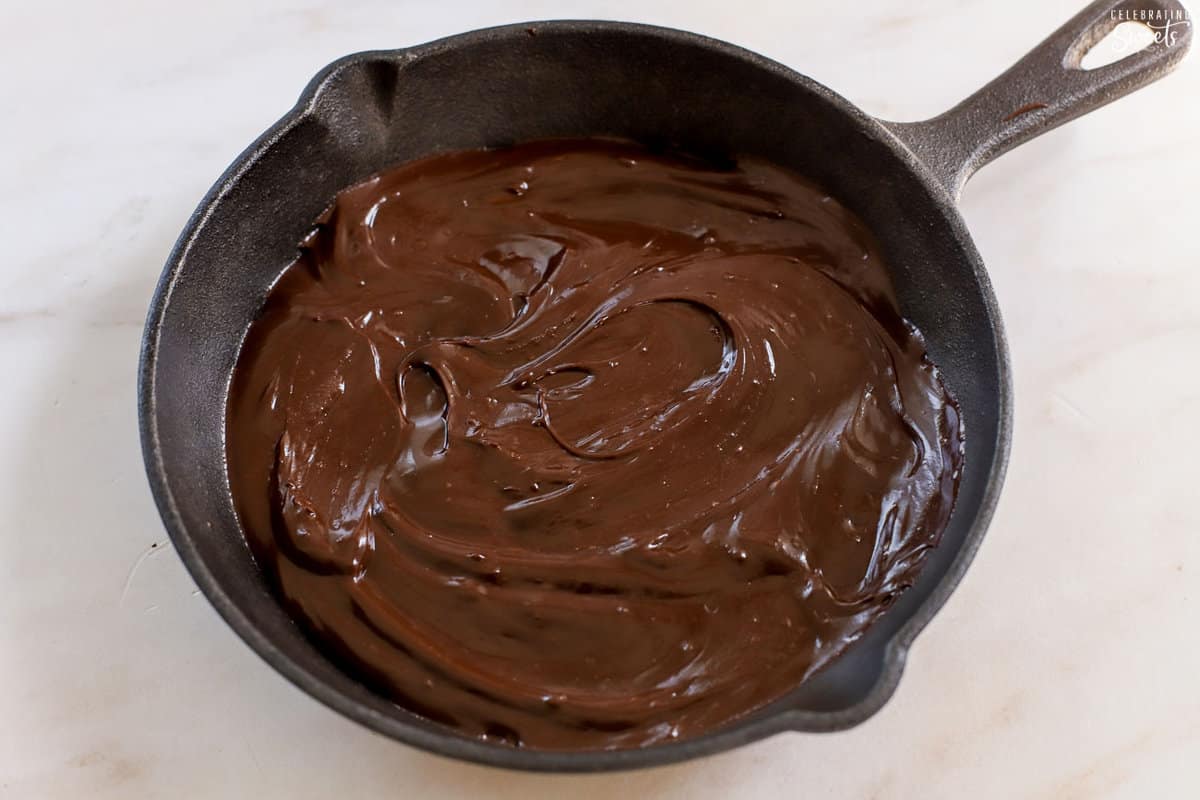 Meted chocolate in a cast iron skillet.