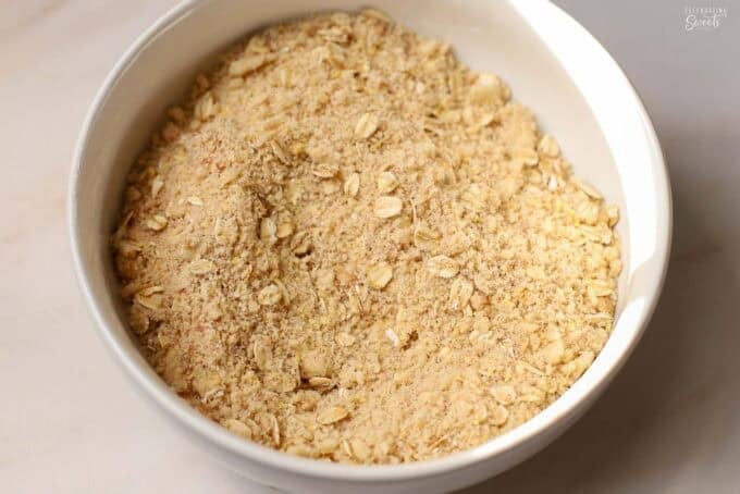 Unbaked crumb topping in a white bowl.