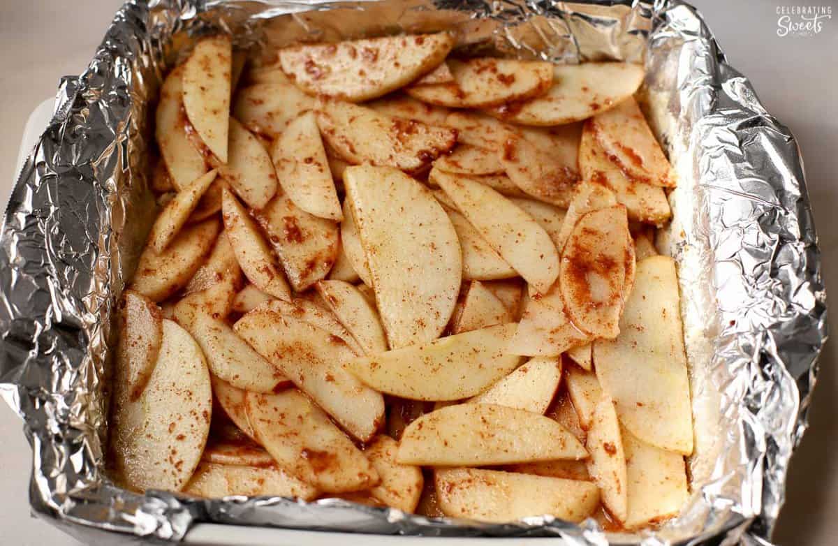 Cinnamon apples in a foil-lined pan.