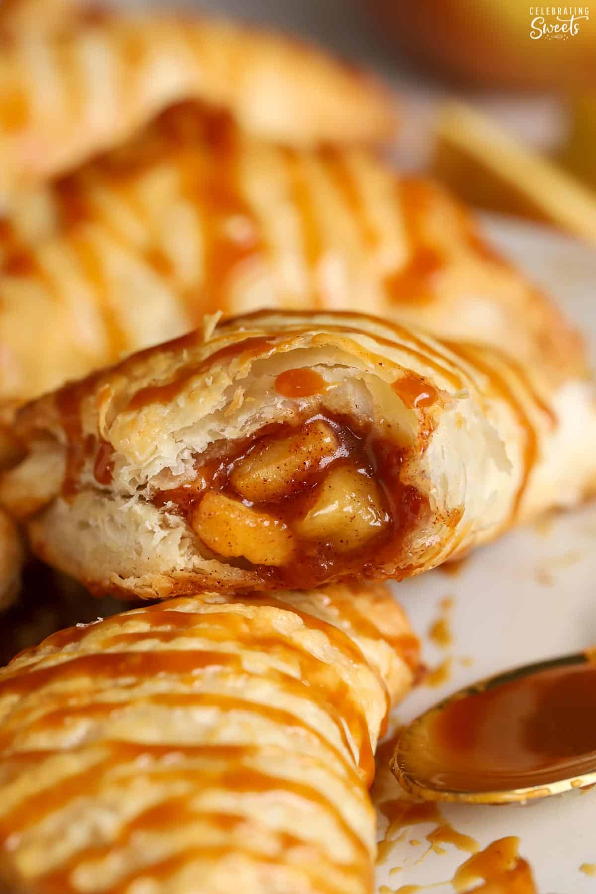 Closeup of an apple turnover with a bite taken out of it.