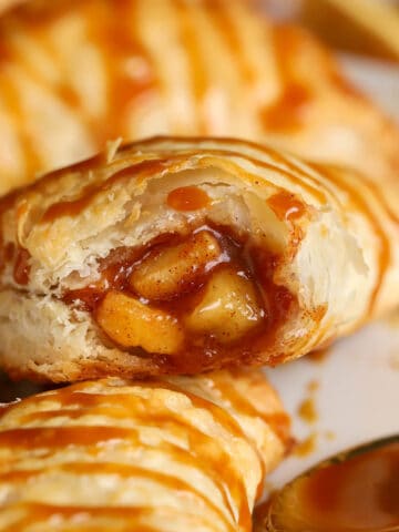 Closeup of an apple turnover with a bite taken out of it.