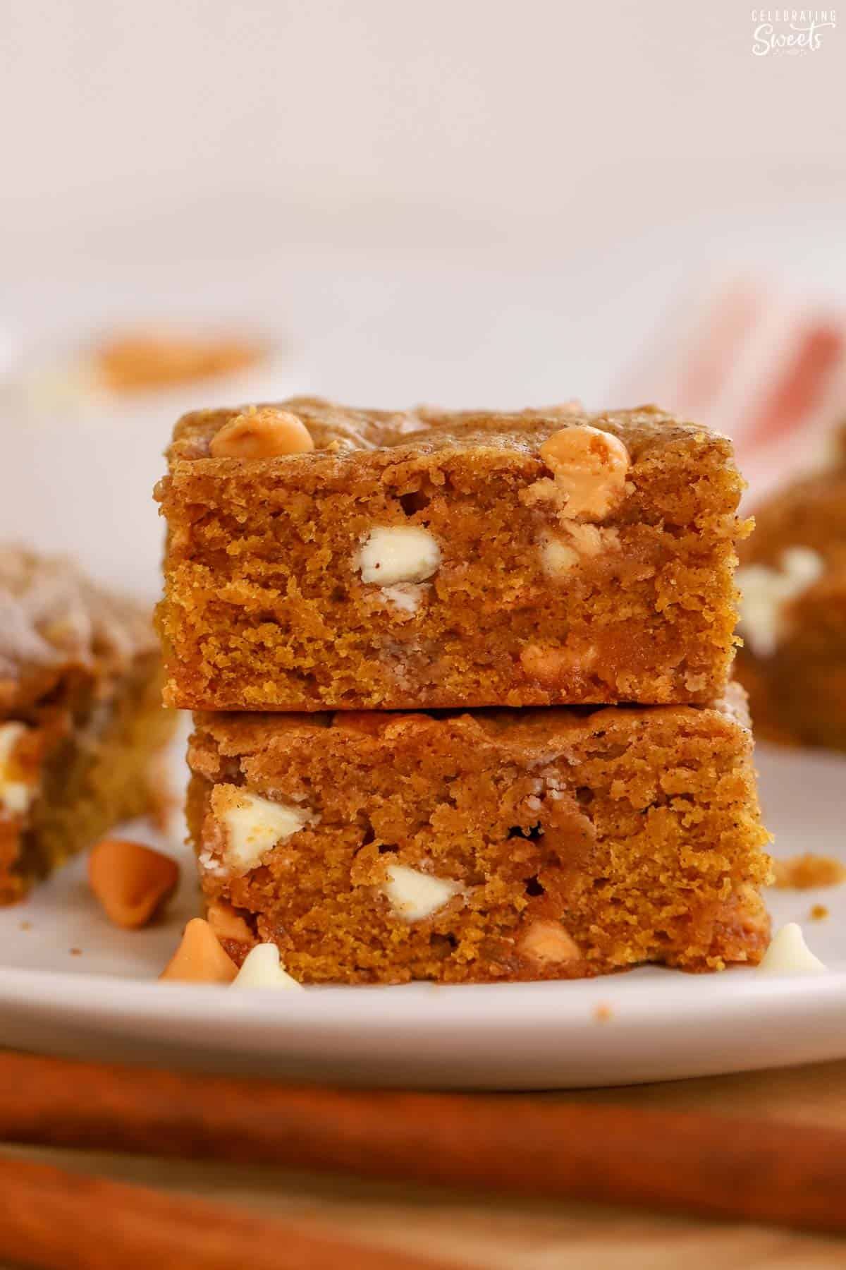 Stack of two pumpkin blondies on a white plate.