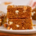 Stack of two pumpkin blondies on a white plate.