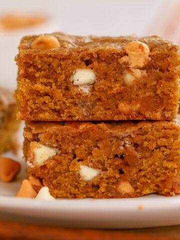 Stack of two pumpkin blondies on a white plate.