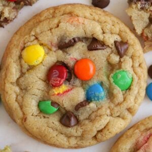 Closeup of an M&M cookie topped with chocolate chips and M&M's.