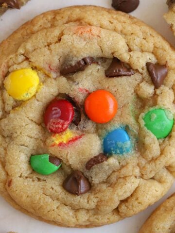 Closeup of an M&M cookie topped with chocolate chips and M&M's.