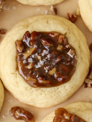 Close up of a pecan pie cookie (sugar cookie filled with caramel pecan filling).