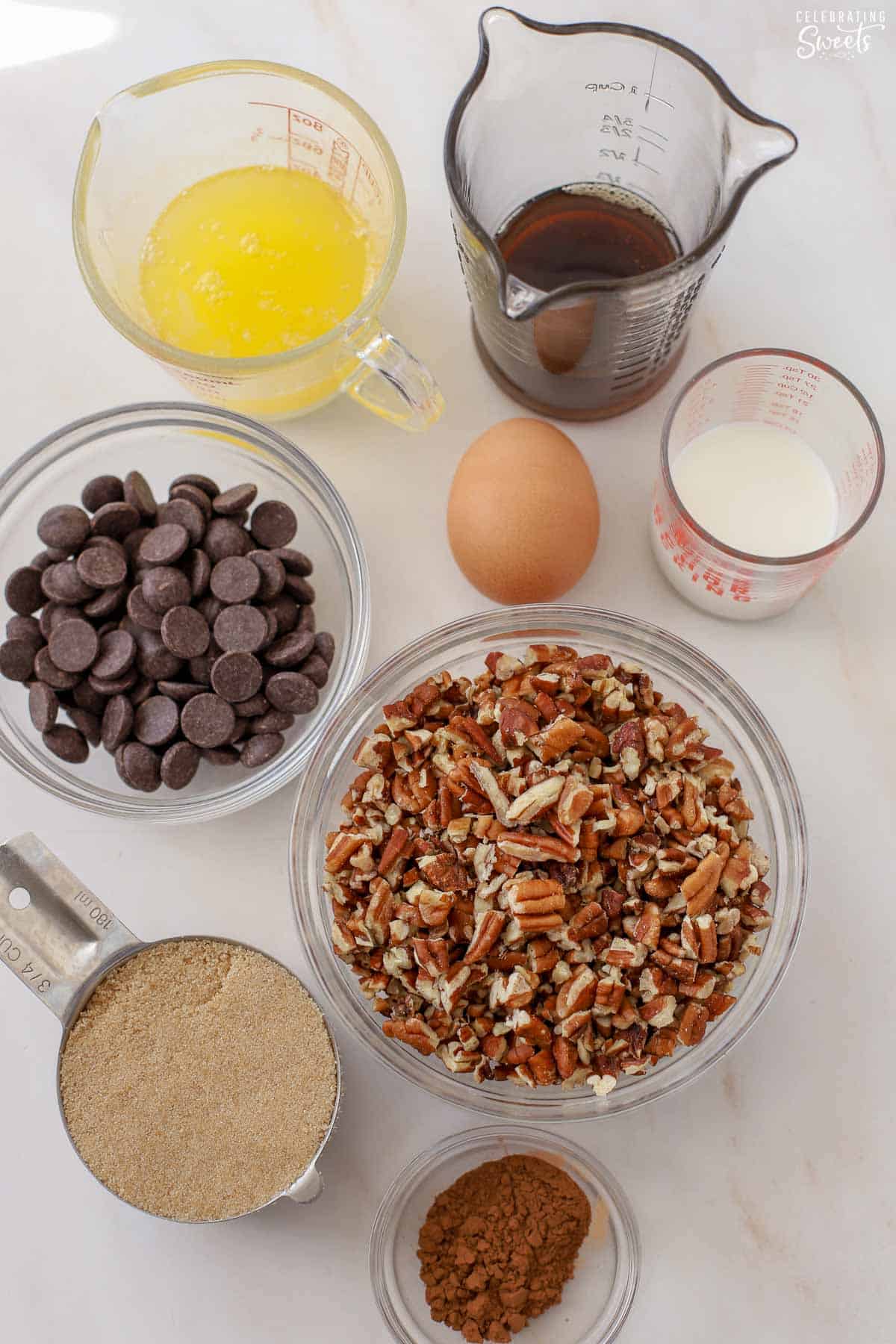 Ingredients for chocolate pecan pie bars: brown sugar, syrup, pecan, chocolate chips, melted butter, egg.