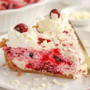 Slice of cranberry cheesecake on a white plate.