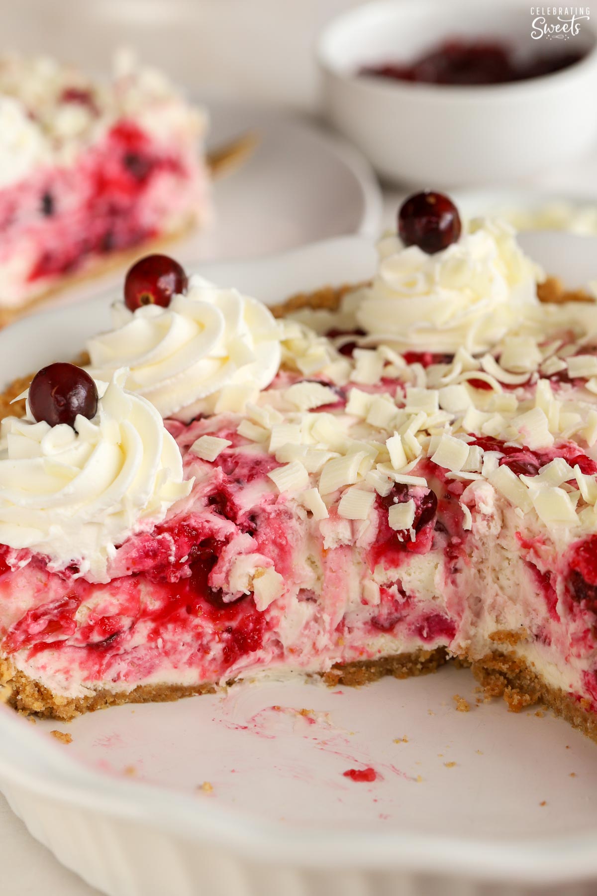 Cranberry cheesecake in a white pie dish.
