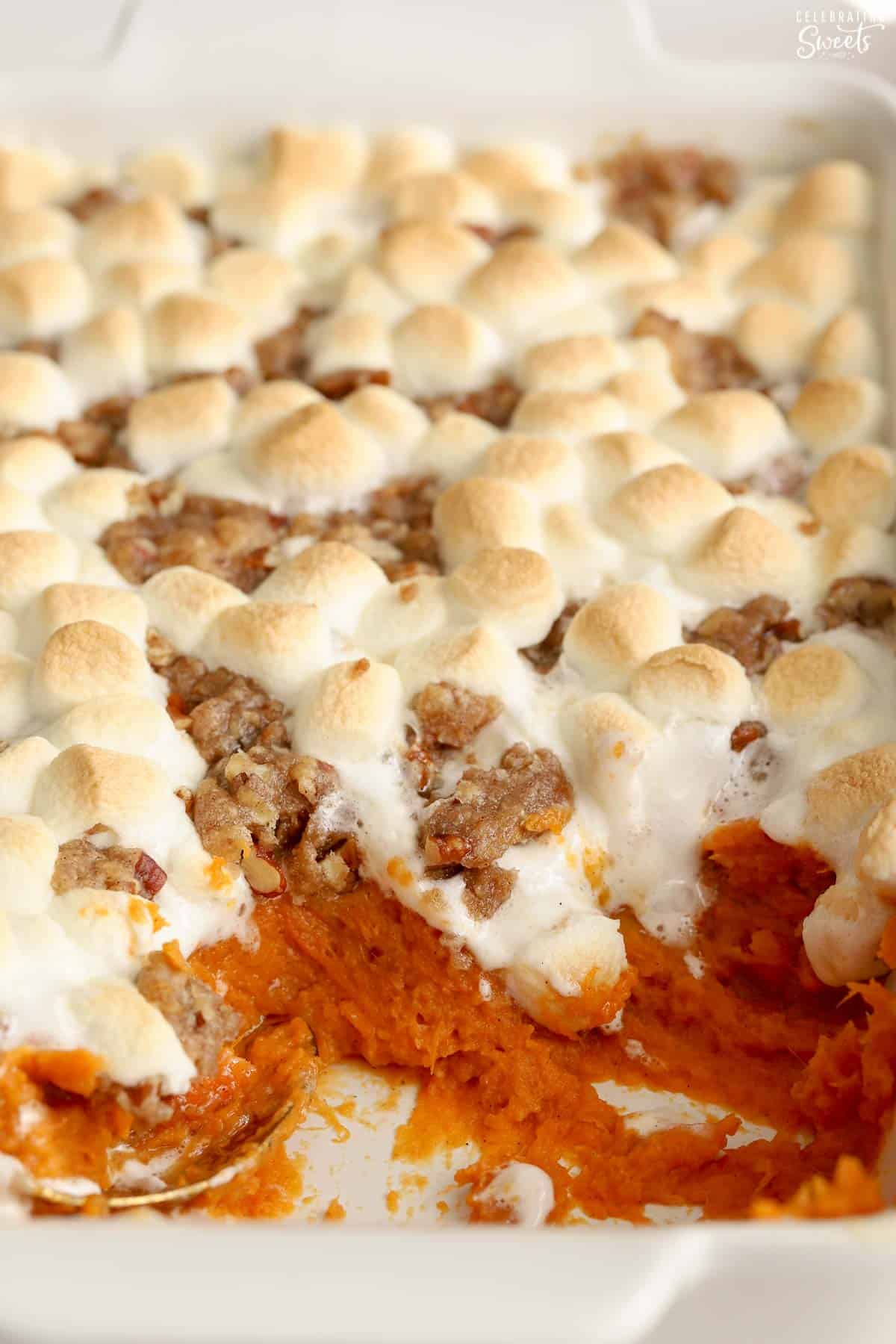 Sweet potato casserole with marshmallows and streusel in a white baking dish.