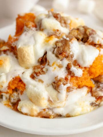 Closeup of sweet potato casserole on a white plate.